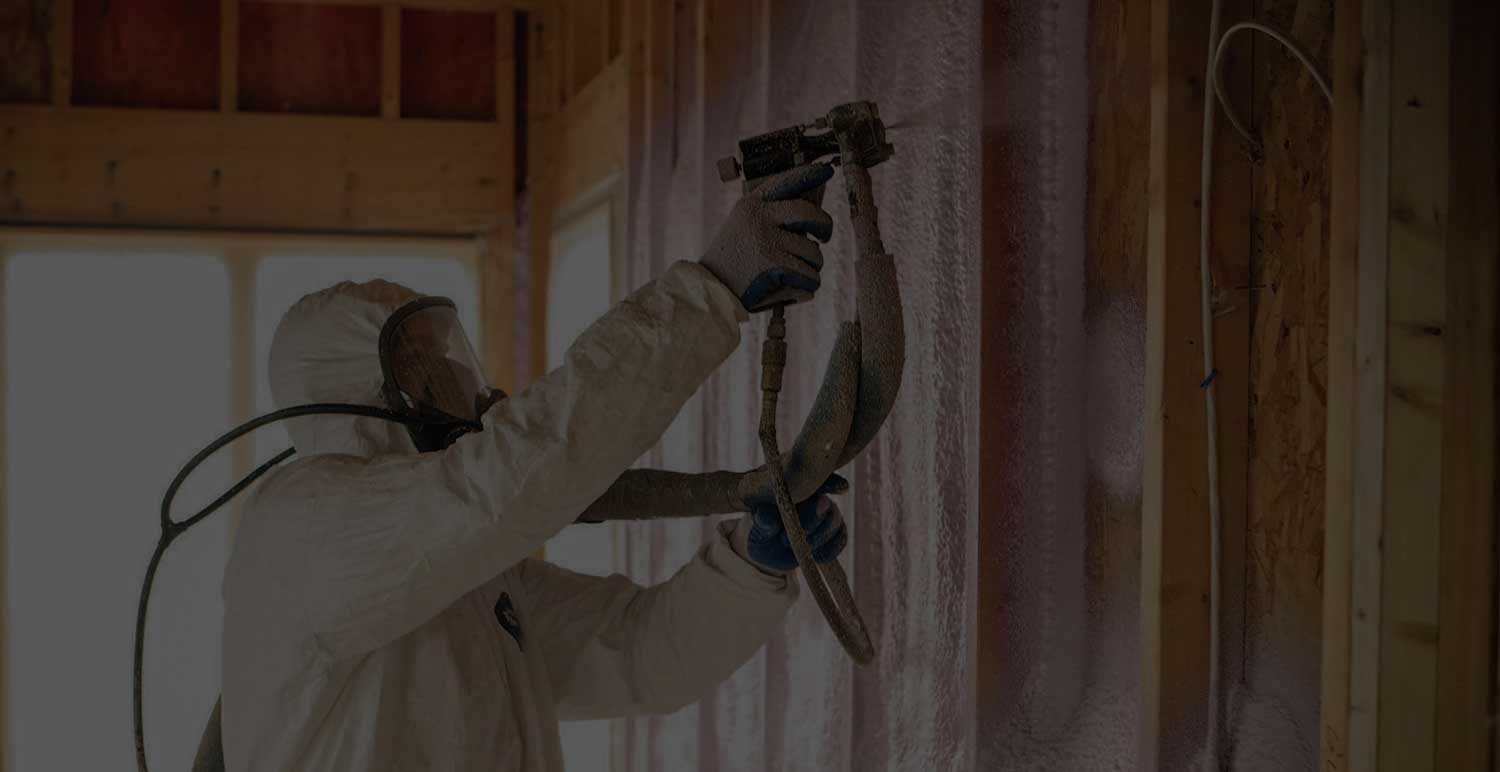 person spraying closed cell insulation in open wall