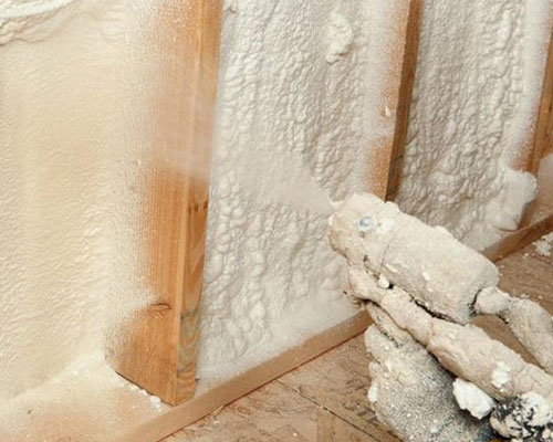 applying spray foam insulation to open walls